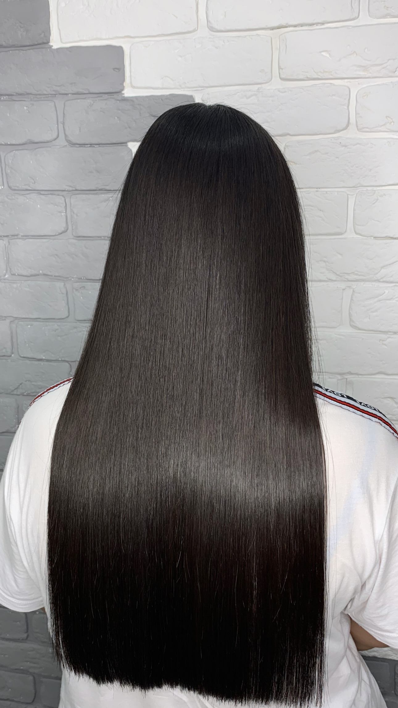 Long, sleek dark hair styled at The Elenas